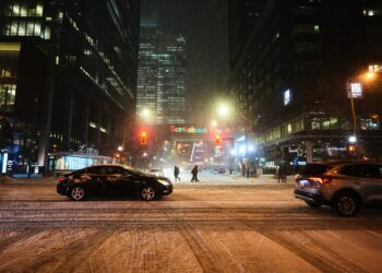 a couple of cars that are sitting in the snow